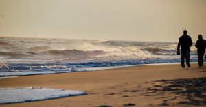 Walking along edge of Jones Beach on Long Island.