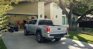 A silver 2018 Toyota Tacoma parked in a suburban driveway.